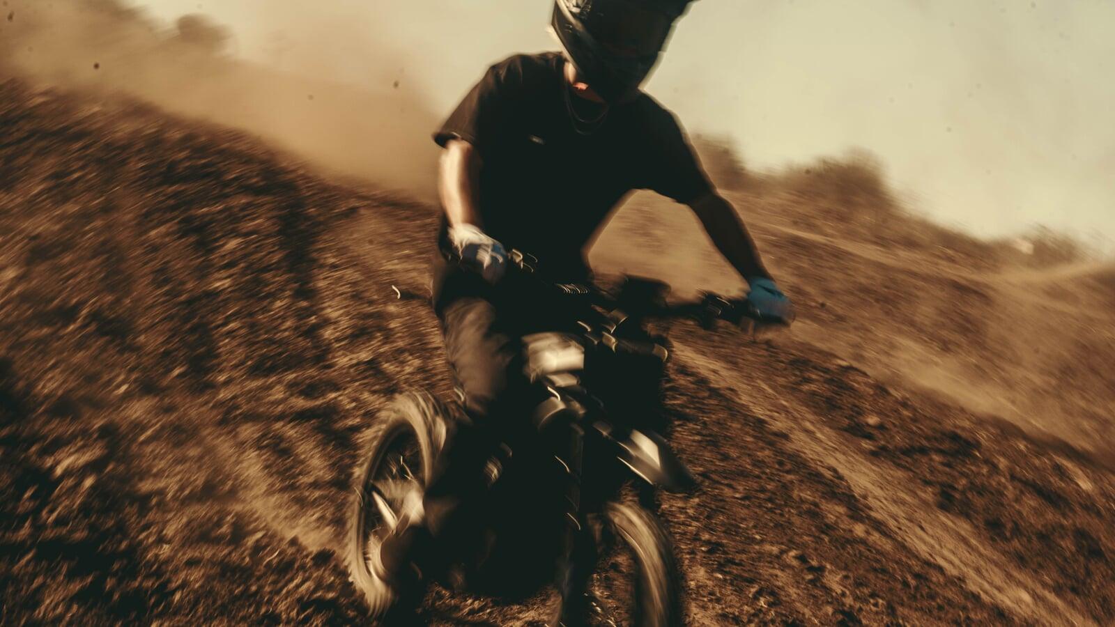 Vtron electric motorcycle riding on a dirt trail